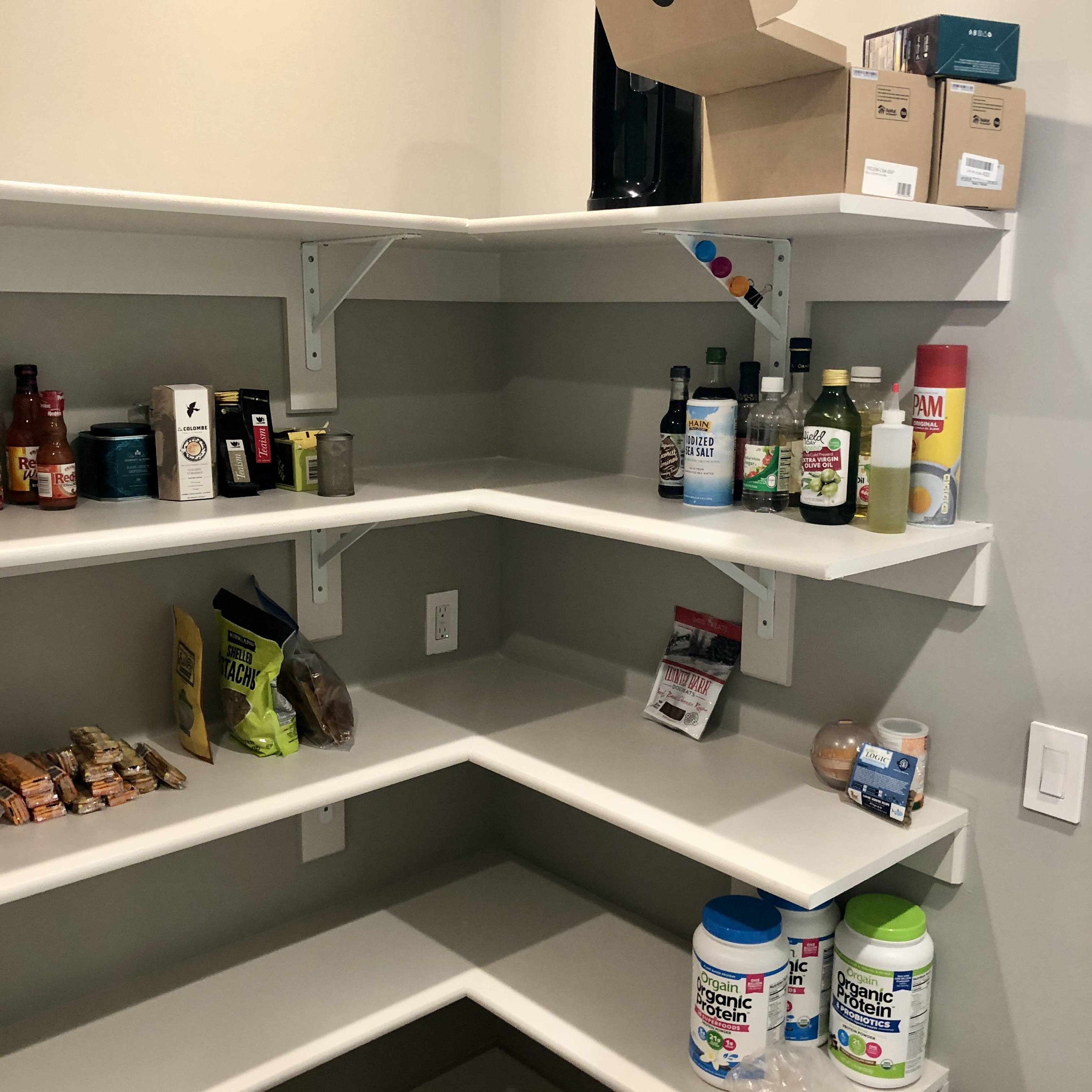 Disorganized kitchen pantry shows items scattered on shelves