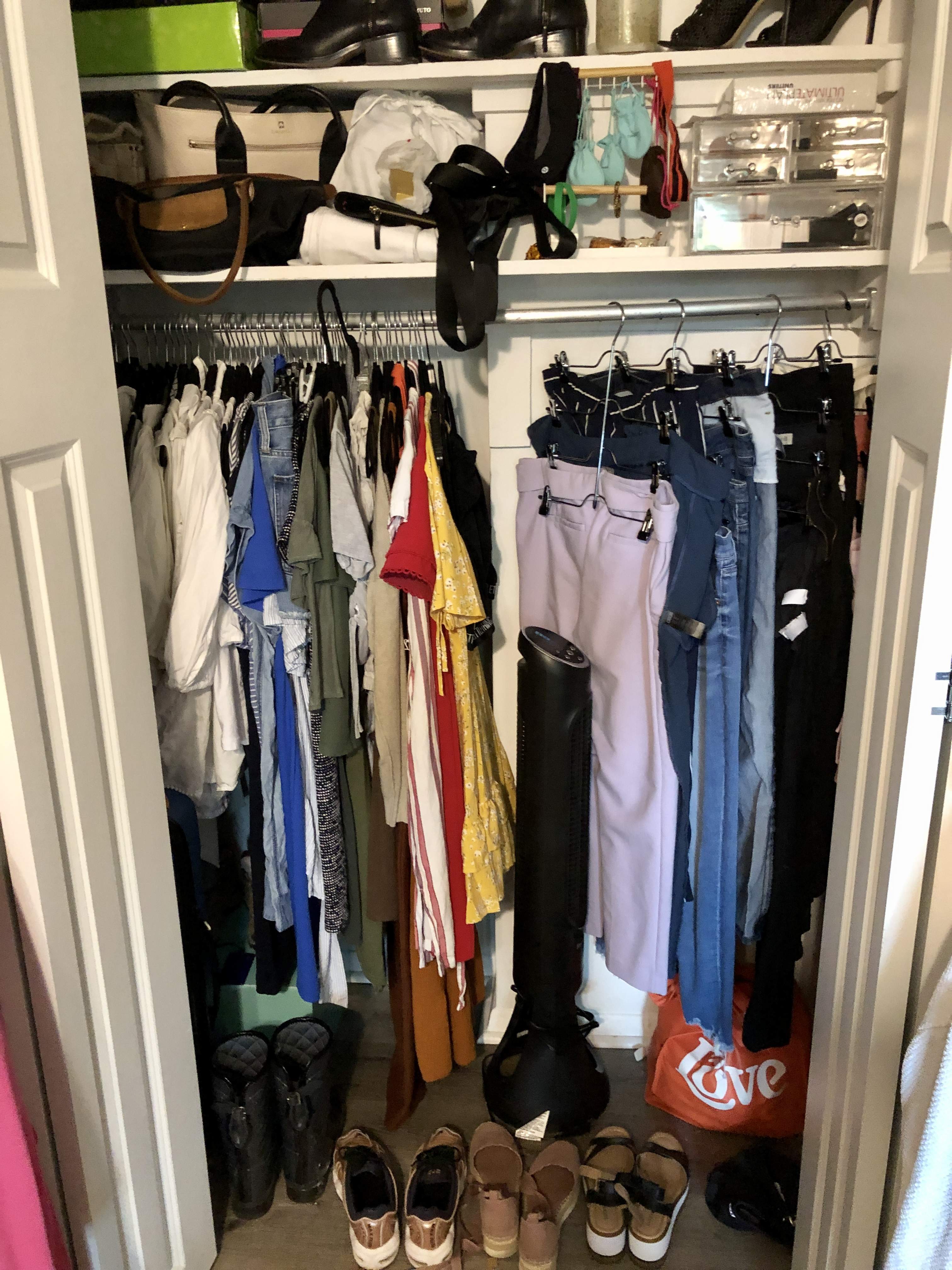 Disorganized closet with clothes not categorized and wasted space at the front